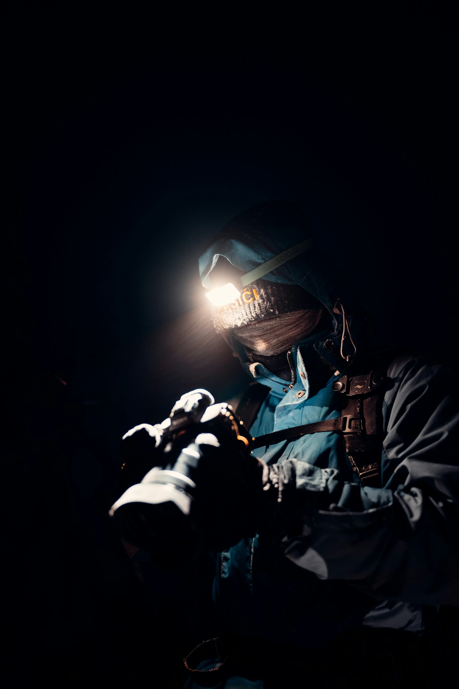 Person holding a flashlight in the dark, the way a night rat call gets worked